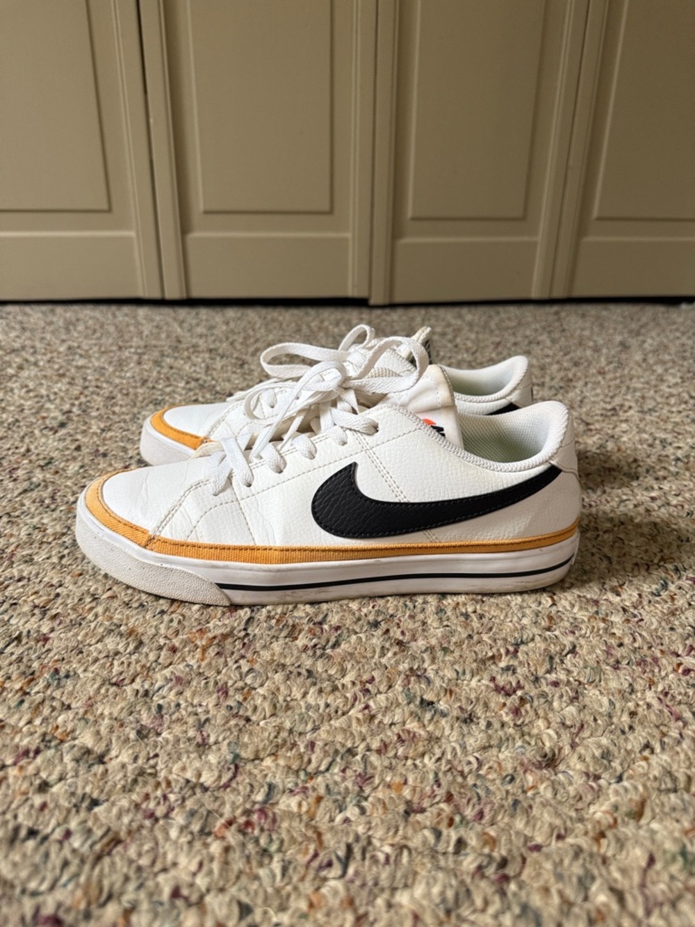 Nike Women’s White Sneakers with Black Swoosh and Gold Trim
